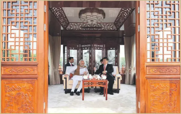  ?? Reuters ?? China’s President Xi Jinping and Indian Prime Minister Narendra Modi share a boat ride on the East Lake in Wuhan, China, during their two-day summit