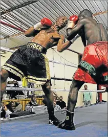  ?? Picture: MICHAEL PINYANA ?? UPPERCUT: Tshifhiwa Munyai leads with a left to challenger Emmanuel Quartey of Ghana during their WBA Pan-African title fight