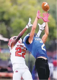  ?? JASON HIRSCHFELD/FREELANCE ?? Phoebus’ Kymari Gray intercepts a pass intended for Hampton’s Aram Williams during a game earlier this season. The Phantoms will visit Oscar Smith tonight.