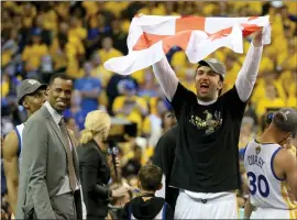  ?? RAY CHAVEZ — STAFF ?? Warriors’ Zaza Pachulia displays a flag of Georgia, his homeland, as he and teammates celebrate June 12 after defeating Cleveland in Game 5 of the NBA Finals.