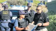  ?? Picture: Dan Meyer Picture: AFP ?? Capt Sharon Jaftha of the police anti-gang unit confiscate­s a PPA guard’s gun.