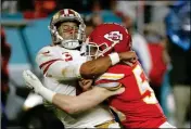  ?? ASSOCIATED PRESS ?? KANSAS CITY CHIEFS linebacker Ben Niemann (right) hits San Francisco 49ers quarterbac­k Jimmy Garoppolo during the second half of Super Bowl 54 Sunday in Miami Gardens, Fla.