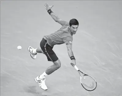  ?? WANG ZHAO / AGENCE FRANCE-PRESSE ?? Novak Djokovic backhands a return against Fabio Fognini during their match at the Shanghai Masters on Tuesday. World No 1 Djokovic breezed to a 6-3, 6-3 victory.