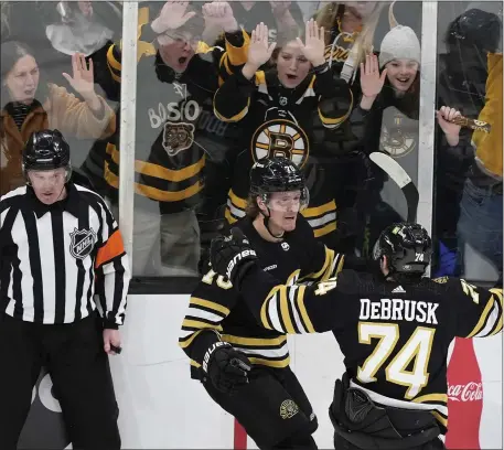  ?? Bruins 3, Panthers 2, OT MICHAEL DWYER — THE ASSOCIATED PRESS ?? Boston Bruins forward Jesper Boqvist celebrates with Jake DeBrusk (74) after scoring in overtime to defeat the Florida Panthers on Saturday at the TD Garden.