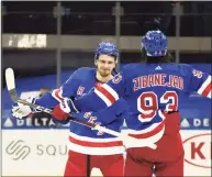  ?? Bruce Bennett / Associated Press ?? The Rangers’ Pavel Buchnevich, left, and Mika Zibanejad celebrate after they defeated the Devils on Saturday. Buchnevich scored three goals.