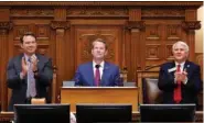  ?? AP PHOTO/ALEX SLITZ ?? Georgia Lt. Gov. Burt Jones, left, and Georgia Speaker of the House Jon Burns, right, applaud Jan. 25 as Georgia Gov. Brian Kemp, center, delivers the State of the State address on the House floor of the state Capitol in Atlanta.