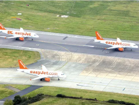  ??  ?? Passenger aircraft operated by Easyjet queue for take off from London Gatwick airport in Crawley, England, on Oct 24, 2016. — WP-Bloomberg photo