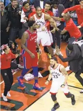  ?? NATHAN DENETTE AP ?? Toronto’s Kawhi Leonard (top center) reacts with teammates after his buzzer shot beat Philadelph­ia.