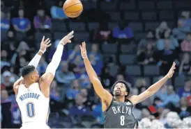  ?? SARAH PHIPPS, THE OKLAHOMAN] [PHOTO BY ?? Oklahoma City’s Russell Westbrook shoots over Brooklyn’s Spencer Dinwiddie during Tuesday’s game at the Chesapeake Energy Arena. The Thunder won, 109-108.