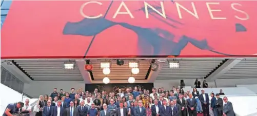  ??  ?? Cannes mayor David Lisnard (center), General Delegate of the Cannes Film Festival Thierry Fremaux (sixth left), President of the Cannes Film Festival Pierre Lescure (eighth left), French actress Isabelle Huppert (fourth right) and staff of the festival observe a minute of silence to pay homage to the victims of the Manchester terrorist attack that occurred a day before, yesterday at the 70th edition of the Cannes Film Festival in Cannes, southern France. — AFP