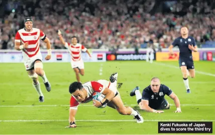  ??  ?? Kenki Fukuoka of Japan dives to score the third try