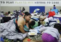  ?? DAVID GOLDMAN / THE ASSOCIATED PRESS FILE ?? Annette Davis kisses her son Darius, 3, while staying at a shelter in Miami after evacuating from their home in Florida City, Fla., ahead of Hurricane Irma.