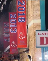  ?? MICHAEL DWYER/ASSOCIATED PRESS ?? The 2018 World Series championsh­ip banner is already hanging outside Fenway Park Monday.