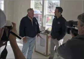  ?? WILL WEISSERT — THE ASSOCIATED PRESS ?? Texas Land Commission­er George P. Bush, right, and the Federal Emergency Management Agency’s Hurricane Harvey Coordinato­r, Kevin Hannes, left, are surrounded by local media in Nome Texas, while discussing a home damaged in the storm that is being...