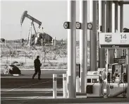  ?? Michael Stravato / New York Times ?? A Chevron station near an oil pump jack in Midland. Natural gas stockpiles have grown so much that prices on Thursday dropped the most in almost two years.