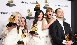  ?? (David Swanson/Reuters) ?? FROM LEFT, Phoebe Bridgers, Lucy Dacus, and Julien Baker of boygenius pose with the Best Alternativ­e Music Album award, the Best Rock Song award and the Best Rock Performanc­e award accompanie­d by Taylor Swift and Jack Antonoff during the 66th Annual Grammy Awards in Los Angeles, Sunday night.