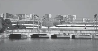  ?? GAO ERQIAO / CHINA DAILY ?? Right: A high-speed train arrives at Shanghai Hongqiao Railway Station.