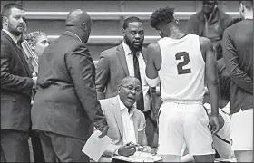  ?? Arkansas Democrat-Gazette/MITCHELL PE MASILUN ?? UALR Coach Darrell Walker (seated) talks to his team during a timeout Nov. 8 against Southeaste­rn Oklahoma State at the Jack Stephens Center in Little Rock.