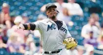  ?? DAVID ZALUBOWSKI/AP ?? Miami third baseman Jean Segura throws to first base to retire Colorado’s Brenton Doyle on Thursday in Denver.