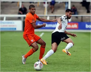  ??  ?? Omar Holness battles for the ball against Hereford