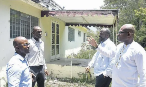  ?? (Photo: Garfield Robinson) ?? Provice-chancellor and principal, The University of the West Indies (The UWI), Mona campus, Professor Densil Williams (right) raises a point to acting estate manager of the campus Milton Dennis (second left) during a tour of some of the houses to be renovated under The UWI’S College Commons Housing Project. Looking on (from left) are project manager of Kayani Constructi­on, Milton Mcintyre and chief executive officer (CEO) of Wentworth Constructi­on Limited, Christophe­r Bowen.
