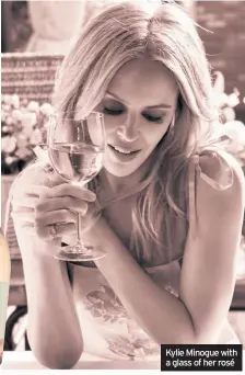  ??  ?? Kylie Minogue with a glass of her rosé