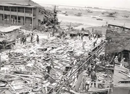  ?? PHOTOS COURTESY OF THE HAMPTON ROADS NAVAL MUSEUM ?? Rescue and clean-up teams sort through the wreckage after a Sept. 17, 1943, ordnance explosion devastated Naval Air Station Norfolk.