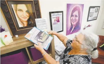  ?? Steve Helber, The Associated Press ?? Susan Bro, the mother of Heather Heyer, who was killed during the Unite the Right rally last year, looks over memorabili­a in her office in Charlottes­ville, Va., on Monday. “I just would like people to focus on the anniversar­y, not on Heather, but on the issues that she died for — Black Lives Matter, overpolici­ng, affordable housing, for more truth.”