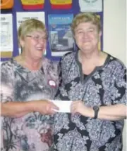  ??  ?? Debbie Brown of Longwarry Lions Club accepts a donation from Drouin Lions Club president Erika Wassenberg.