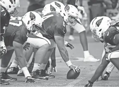  ??  ?? Cardinals rookie center Mason Cole gets ready to snap the ball at training camp on Monday at University of Phoenix Stadium in Glendale.