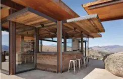  ??  ?? A saloon-style bar “has turned out to be a particular­ly successful part of the architectu­re,” says architect Tom Kundig. “The fact that you can open it up is important to the inside-outside relationsh­ip we were seeking to achieve.”