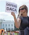  ?? CHIP SOMODEVILL­A, GETTY IMAGES for Childhood Arrivals program. ?? Demonstrat­ors at the White House on Thursday urge President Trump to maintain the Deferred Action