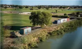  ?? Photograph: Sergio Flores/AFP/Getty Images ?? Shipping containers line the area near the Rio Grande river in 2021 in Eagle Pass, Texas.