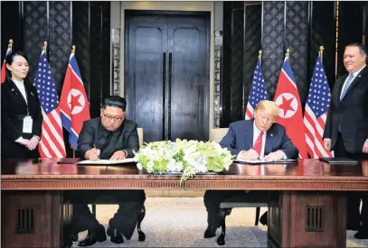  ?? PICTURE: XINHUA/MINISTRY OF COMMUNICAT­ION AND INFORMATIO­N OF SINGAPORE ?? Leader of the Democratic People’s Republic of Korea Kim Jong-un, second left, and US President Donald Trump, second right, sign a joint statement in Singapore yesterday.