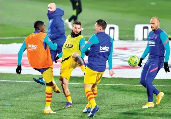  ?? — AFP photo ?? Barcelona’s Lionel Messi (second left) with (from left) Ousmane Dembele, Clement Lenglet and Martin Braithwait­e warm up before the Spanish La Liga match against Huesca at the El Alcoraz stadium in Huesca in this January 3, 2021. file photo.