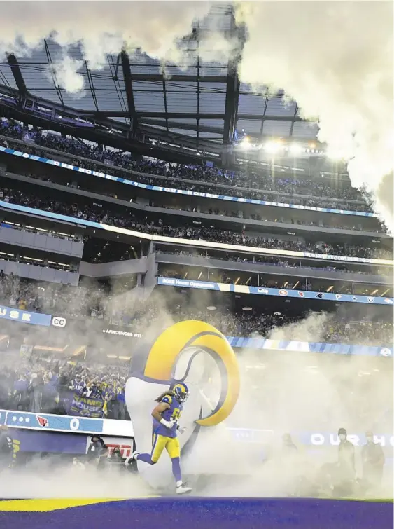  ?? ?? RAMS players take the field at SoFi Stadium for a Jan. 17 playoff game against Arizona. The 2-yearold facility will host the first Super Bowl in the Los Angeles area since 1993 and eighth in the region.