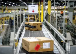  ?? WATCHARA PHOMICINDA — STAFF PHOTOGRAPH­ER ?? The logistics sector has been on the rise in the Inland Empire, with an increase of 56,400 workers compared to February 2020. A package is seen here as it moves along a conveyor belt at an Amazon fulfillmen­t center in Eastvale.