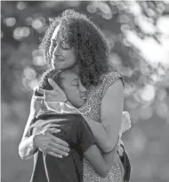  ?? JESSICA PHELPS/NEWARK ADVOCATE ?? Dr. Janae Davis embraces her daughter, Mara Royster, after she spoke at a forum her older sister, Jadyn Paige, organized in summer of 2020.