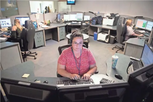  ?? LAUREN PETRACCA/USA TODAY NETWORK ?? Mary Brown takes 911 calls in the call center in Greenville County, S.C.