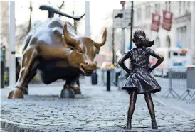  ?? [AP PHOTO] ?? The Charging Bull and Fearless Girl statues are set on Lower Broadway in New York. Since 1989, the bronze bull has stood in New York City’s financial district as an image of the hard-charging spirit of Wall Street. But the installati­on of the bold girl...