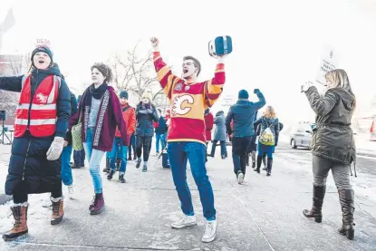  ?? AAron Ontiveroz, The Denver Post ?? Senior Matt Pence holds a speaker over his head as East High School teachers picket during the first day of the strike across Denver Public Schools on Monday.