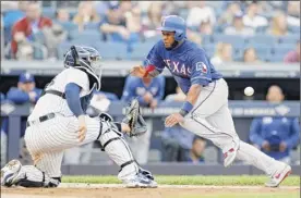  ?? Jim Mcisaac / Getty Images ?? Texas’ Elvis Andrus is tagged out at home by New York’s Gary Sanchez in the fifth inning of the Rangers’ 7-0 win over the Yankees on Monday.