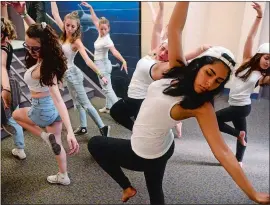  ?? SARAH GORDON/THE DAY ?? The Williams School senior Antonella Portugal, front, performs “The Time Machine,” a dance she also choreograp­hed with classmates, last week during the school’s Enviro7 performanc­es in New London. Dance is just one of many passions for Portugal, whose...