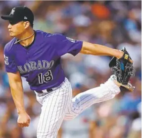  ?? David Zalubowski, The Associated Press ?? Rockies relief pitcher Seunghwan Oh works against the Los Angeles Dodgers during the eighth inning Saturday night at Coors Field. Oh pitched a perfect inning, and the Rockies won the game in the ninth.
