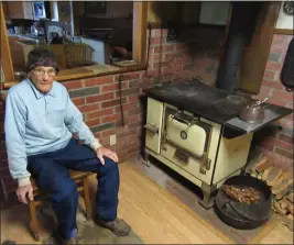  ?? CONTRIBUTE­D ?? James Ciro seated in one of his favorite spots next to “The Hog,” a Monarch wood cook stove he purchased in Fort Bragg about 70years ago for $45.