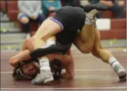  ?? AUSTIN HERTZOG - MEDIANEWS GROUP ?? Phoenixvil­le’s Anthony Stevenson (mask) works a defensive pin on Shane Caffrey at 152 pounds Wednesday.