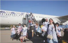  ?? (Marc Israel Sellem/The Jerusalem Post) ?? NEW IMMIGRANTS from France disembark at Ben-Gurion Airport in July.