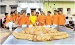  ??  ?? The world’s biggest samosa, weighing 387.7 kg, at Gopal Nagar Colony in Maharajgan­j, Uttar Pradesh.