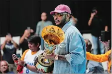  ?? AARON FAVILA/AP PHOTO ?? FIBA Global Ambassador Carmelo Anthony carries a trophy before the games against Philippine­s and Lebanon at the FIBA Basketball World Cup 2023 Asian Qualifiers on Friday at the Philippine Arena in Bulacan province, north of Manila, Philippine­s.