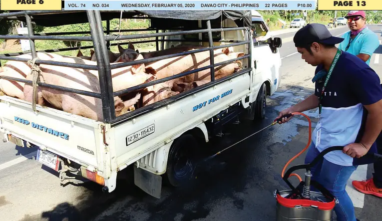  ??  ?? A CITY Veterinary Office employee sanitizes the tires of a vehicle loaded with hogs coming from a farm in Toril at the Task Force Davao checkpoint in Barangay Sirawan, Toril District. The city has banned live hogs and pork meat products from Davao Occidental and Davao del Sur following reports of African Swine Fever cases in the southern tip of Davao region. BING GONZALES